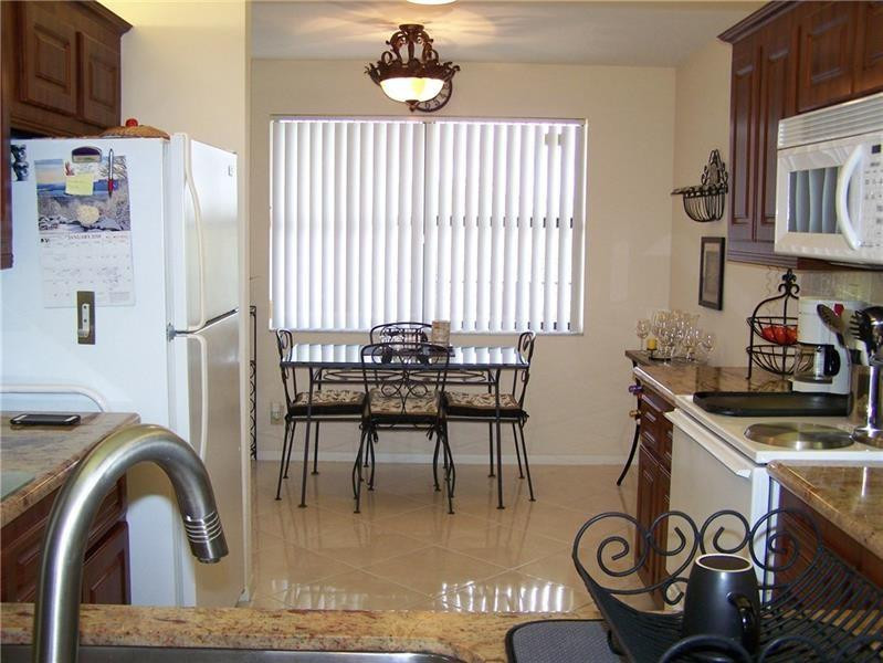 2981 North Nob Hill Road, Unit 406 Sunrise, FL 33322 - Photo 6 of 24 a dining room with furniture and window