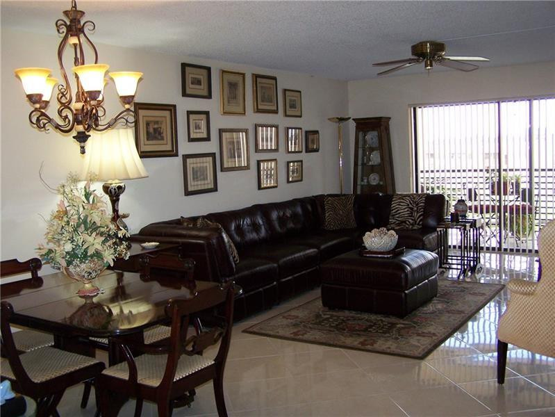 2981 North Nob Hill Road, Unit 406 Sunrise, FL 33322 - Photo 8 of 24 a living room with furniture flowerpot and wooden floor