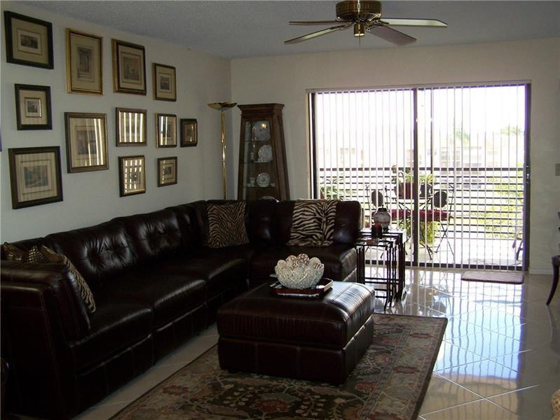 2981 North Nob Hill Road, Unit 406 Sunrise, FL 33322 - Photo 9 of 24 a living room with furniture and a window