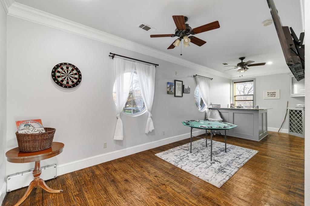 689 Jim Cannon Road Van Alstyne, TX 75495 - Photo 25 of 35 Game room featuring ornamental molding, a baseboard radiator, dark wood-style flooring, and plenty of natural light