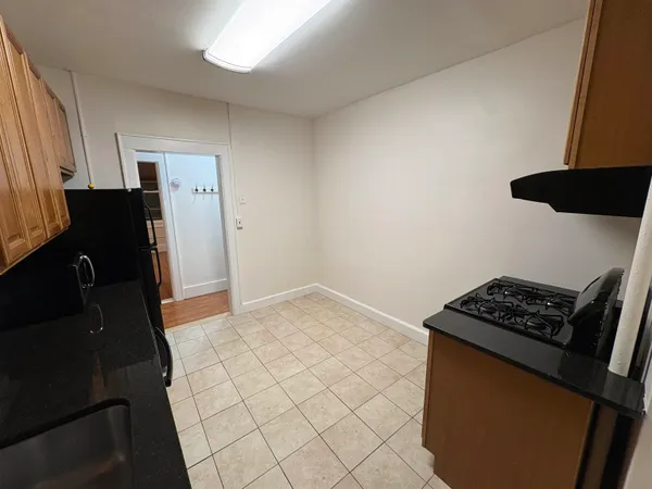 a bedroom with a bed and a stove