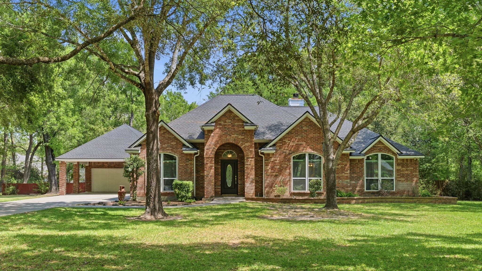 11714 Creek View Lane Conroe, TX 77385 - Photo 1 of 46 a front view of a house with a garden