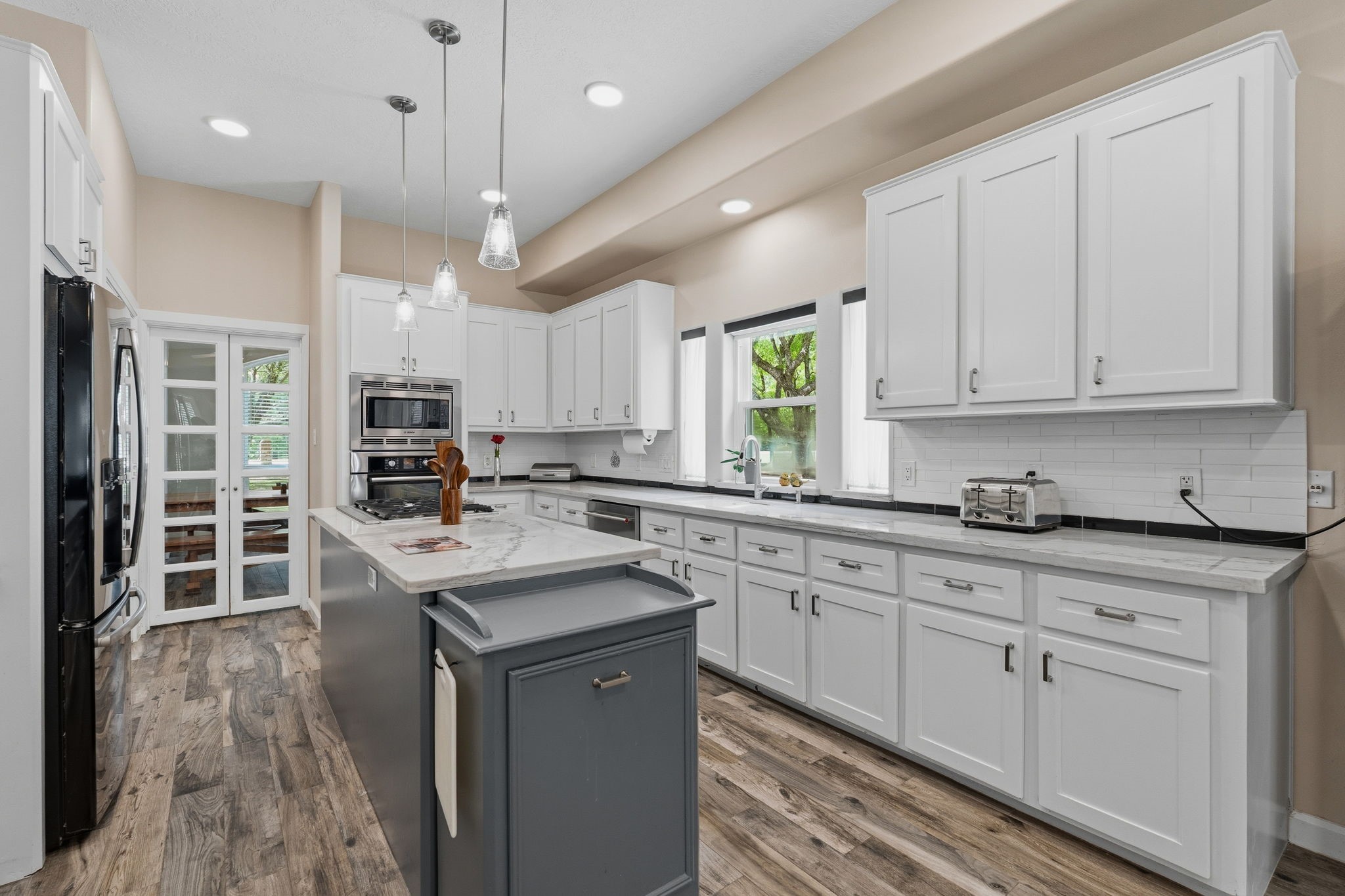 11714 Creek View Lane Conroe, TX 77385 - Photo 12 of 46 a kitchen with granite countertop a sink a counter space appliances and cabinets
