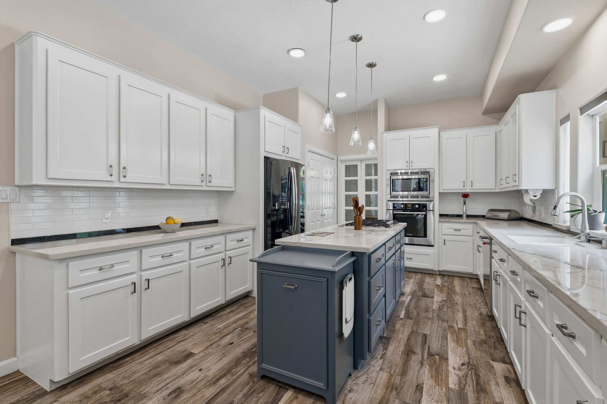 11714 Creek View Lane Conroe, TX 77385 - Photo 13 of 46 a kitchen with stainless steel appliances granite countertop a table chairs sink and cabinets