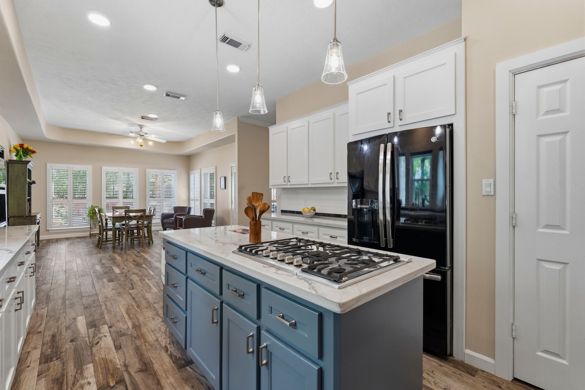 11714 Creek View Lane Conroe, TX 77385 - Photo 14 of 46 a kitchen with a table chairs refrigerator and wooden cabinets
