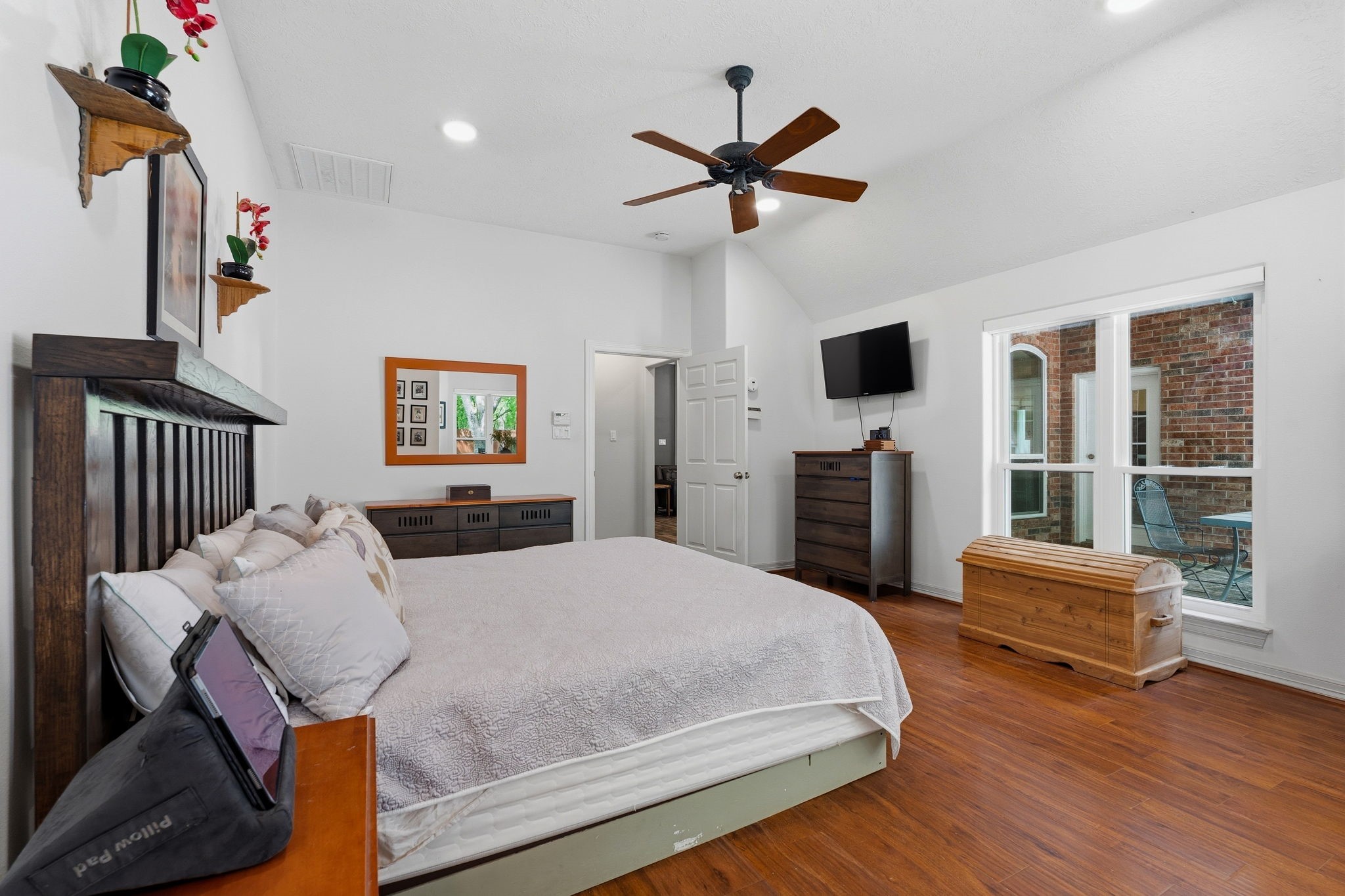11714 Creek View Lane Conroe, TX 77385 - Photo 18 of 46 a bedroom with a bed furniture and a flat screen tv