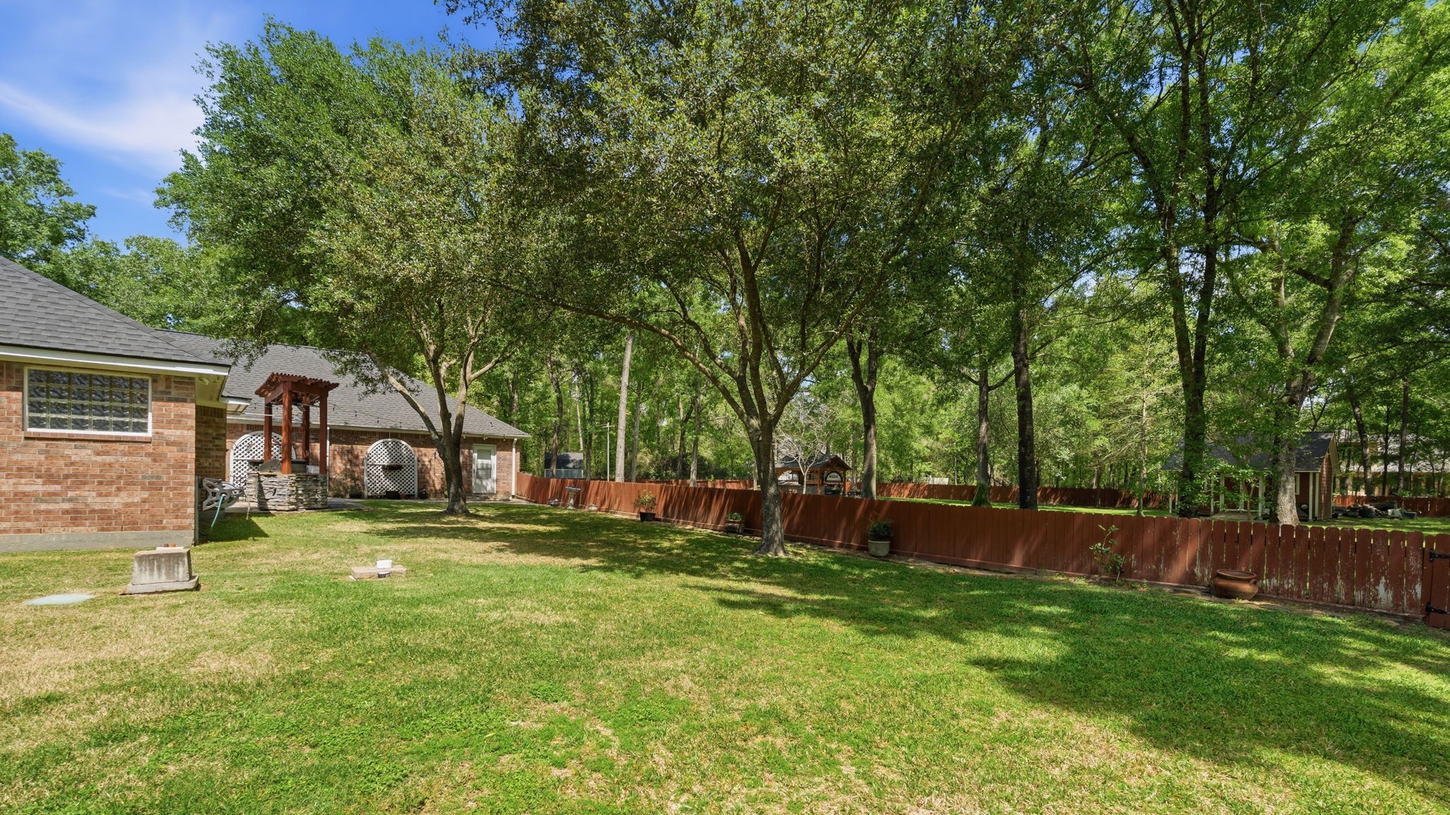 11714 Creek View Lane Conroe, TX 77385 - Photo 36 of 46 a view of a house with a big yard and a large tree