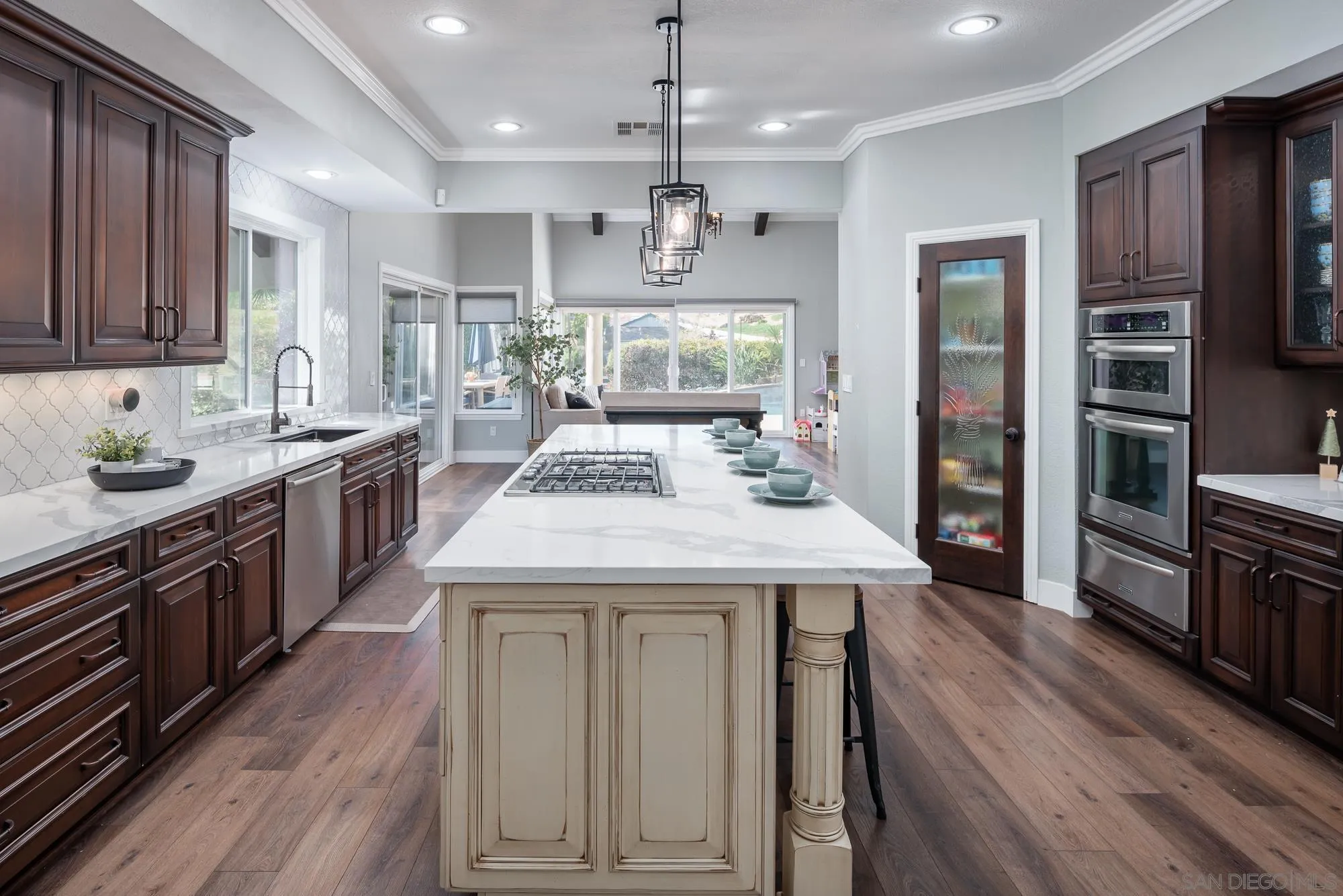 14298 Ipava Drive Poway, CA 92064 - Photo 14 of 74 a kitchen with kitchen island granite countertop wooden floors and stainless steel appliances