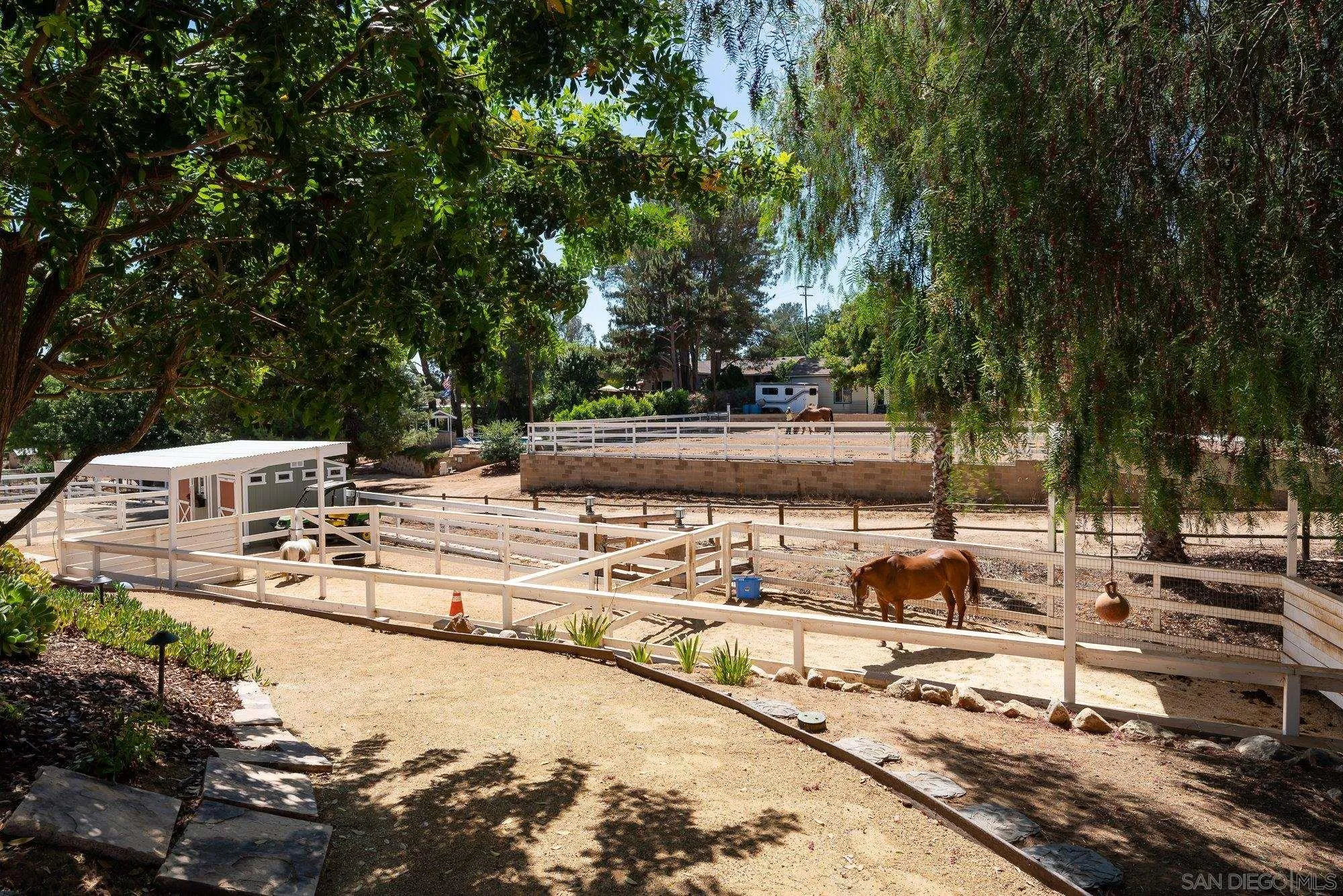 14298 Ipava Drive Poway, CA 92064 - Photo 49 of 74 a view of a swimming pool with a lawn chairs and trees