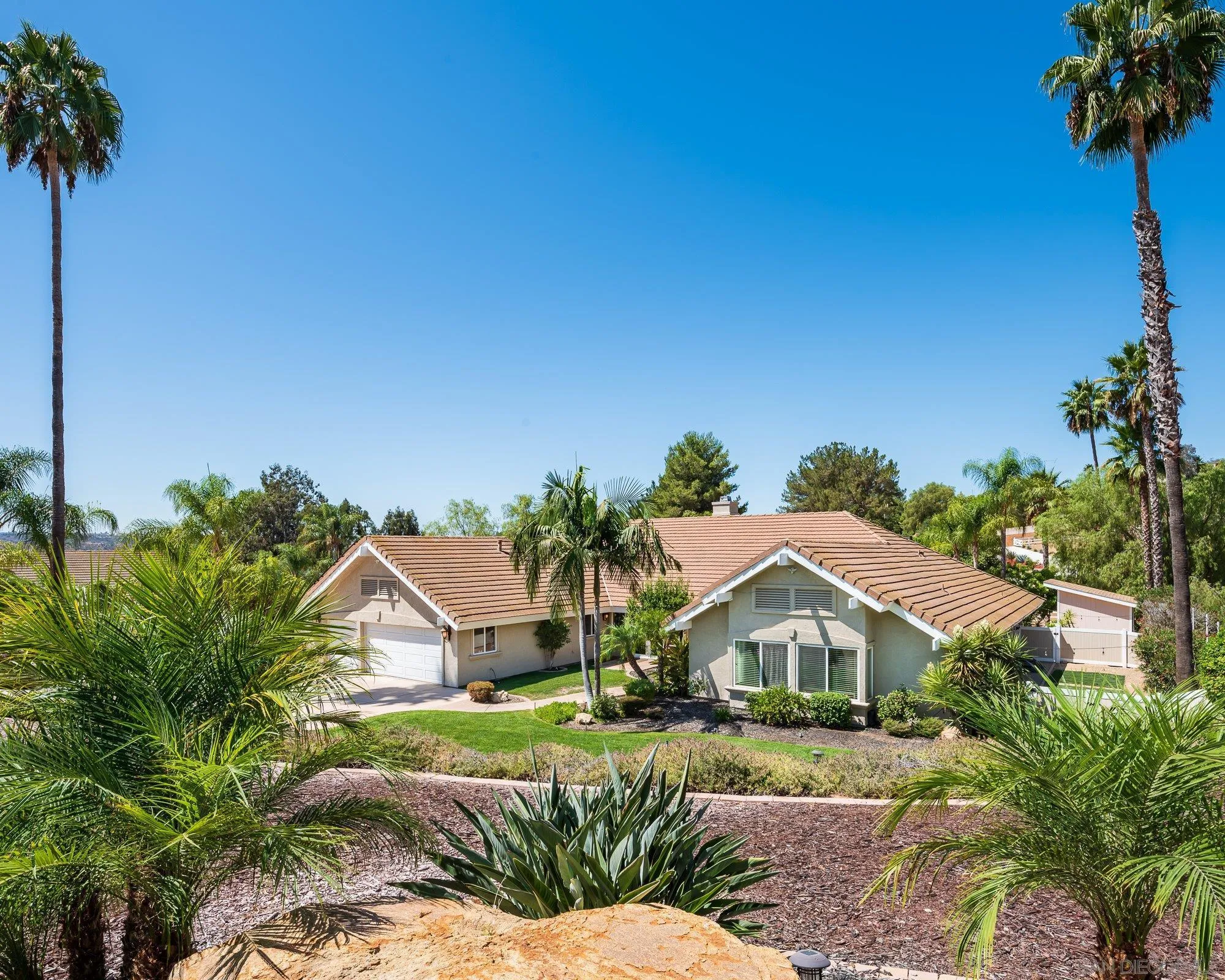 14298 Ipava Drive Poway, CA 92064 - Photo 65 of 74 a front view of a house with a yard and garage