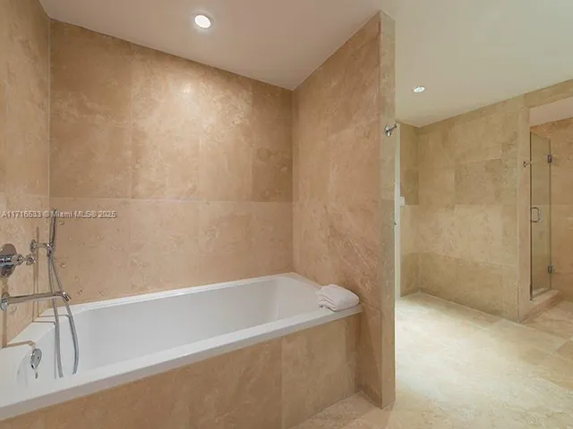 a bathroom with a bathtub and shower