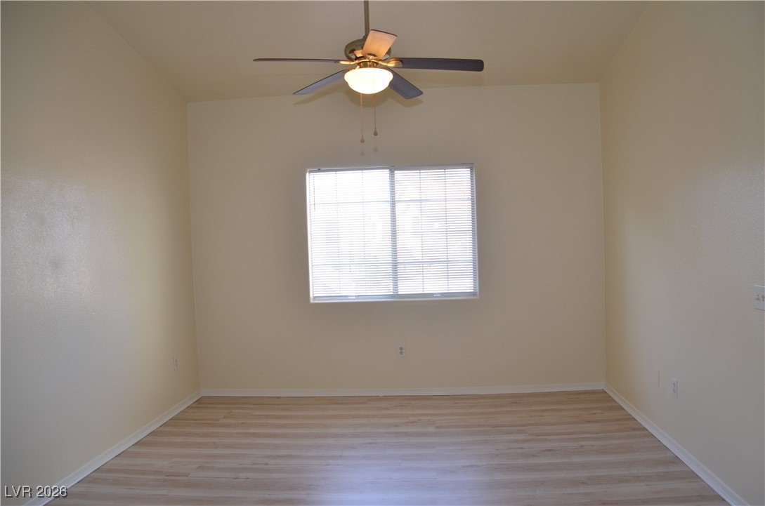 1881 West Alexander Road, Unit 2101 North Las Vegas, NV 89032 - Photo 16 of 37 Empty room with light wood finished floors and ceiling fan