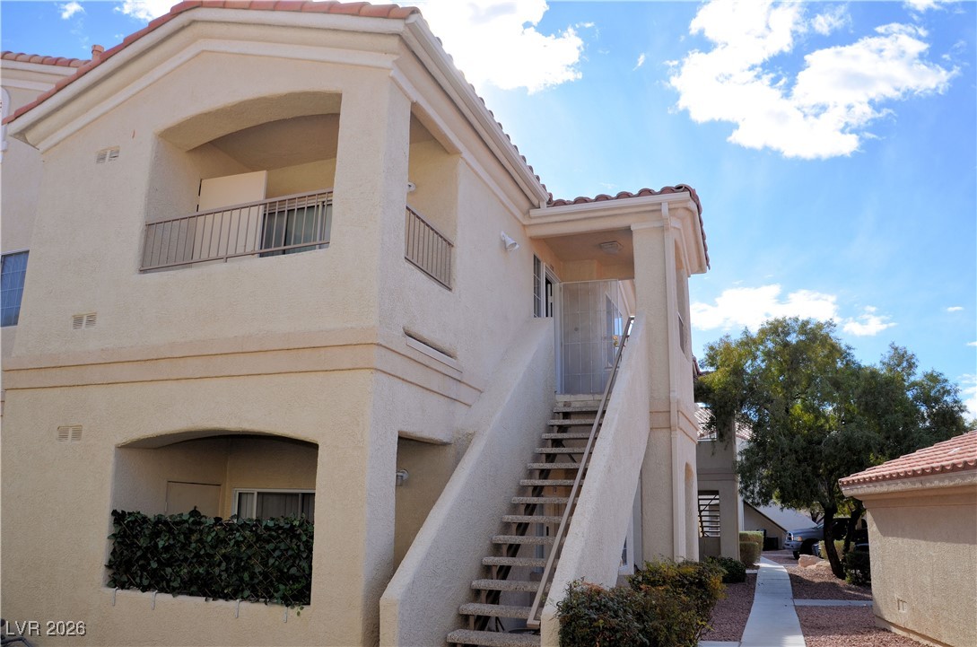 1881 West Alexander Road, Unit 2101 North Las Vegas, NV 89032 - Photo 2 of 37 View of building exterior featuring stairway