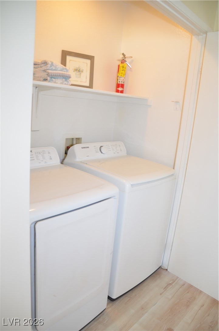 1881 West Alexander Road, Unit 2101 North Las Vegas, NV 89032 - Photo 24 of 37 Washroom featuring light wood-style flooring and washing machine and dryer