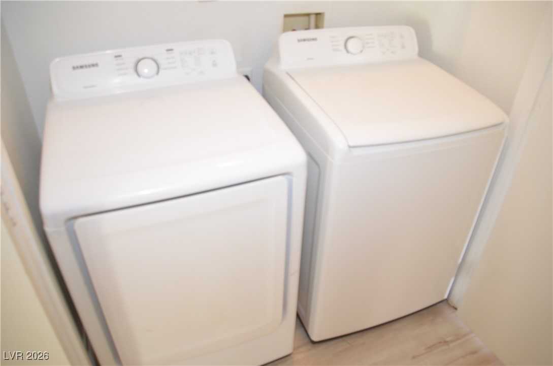 1881 West Alexander Road, Unit 2101 North Las Vegas, NV 89032 - Photo 32 of 37 Laundry area featuring washing machine and clothes dryer and light wood-style floors