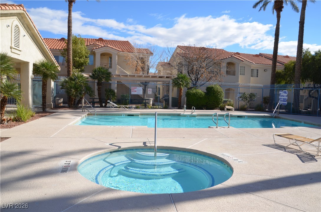 1881 West Alexander Road, Unit 2101 North Las Vegas, NV 89032 - Photo 33 of 37 Community pool with a patio area, a hot tub, and a pergola
