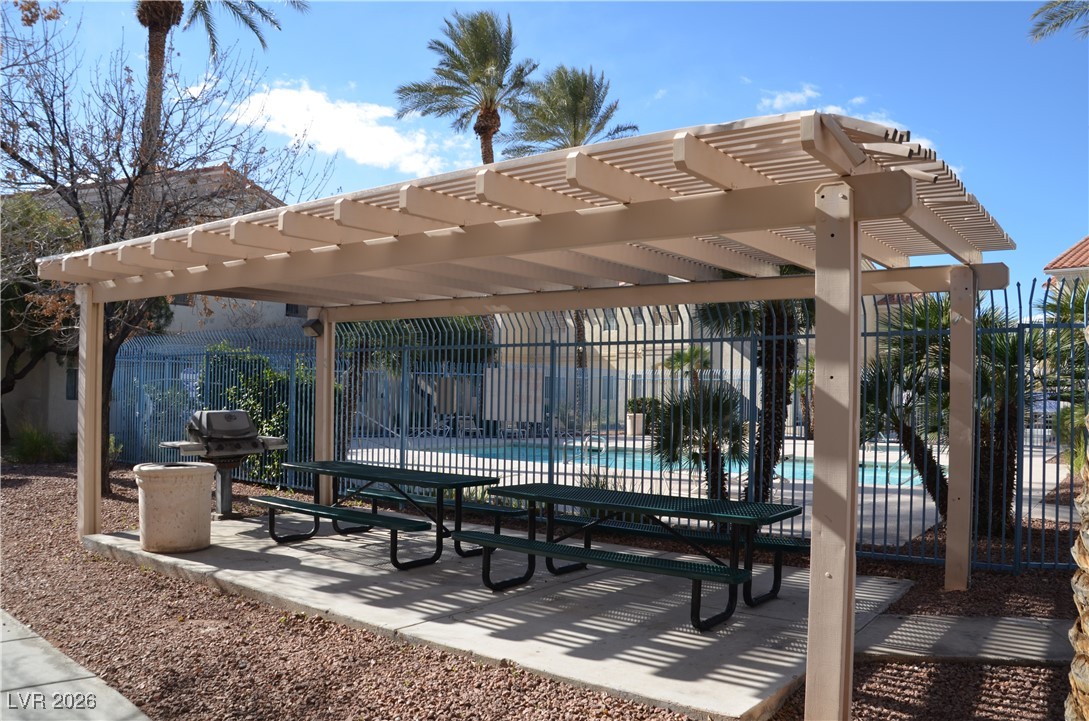 1881 West Alexander Road, Unit 2101 North Las Vegas, NV 89032 - Photo 35 of 37 View of property's community featuring a swimming pool, a patio area, and a pergola