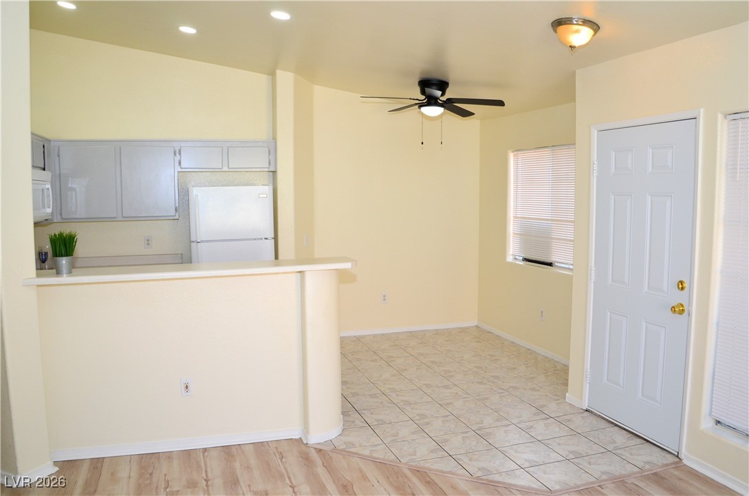 1881 West Alexander Road, Unit 2101 North Las Vegas, NV 89032 - Photo 7 of 37 Kitchen with white appliances, light countertops, a peninsula, gray cabinets, and a ceiling fan