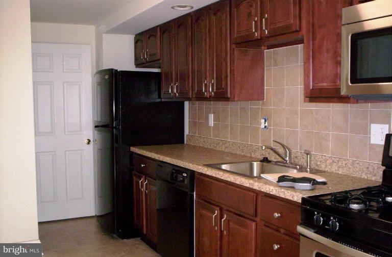 5501 Whitby Road Baltimore, MD 21206 - Photo 1 of 21 a kitchen with a sink stove and refrigerator