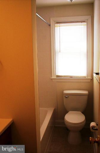 5501 Whitby Road Baltimore, MD 21206 - Photo 15 of 21 a bathroom with a toilet a sink and a window