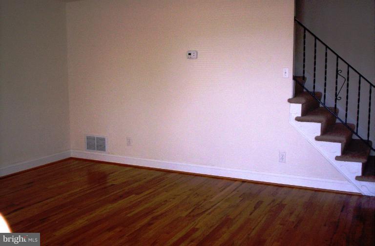 5501 Whitby Road Baltimore, MD 21206 - Photo 4 of 21 a view of a room with wooden floor and brick walls