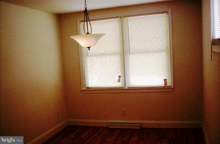 5501 Whitby Road Baltimore, MD 21206 - Photo 6 of 21 a view of empty room with wooden floor and fan