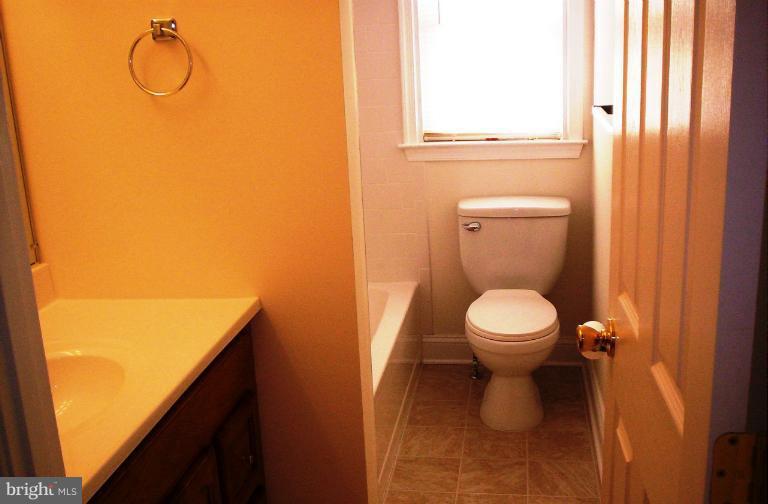 5501 Whitby Road Baltimore, MD 21206 - Photo 7 of 21 a bathroom with a toilet and a shower curtain