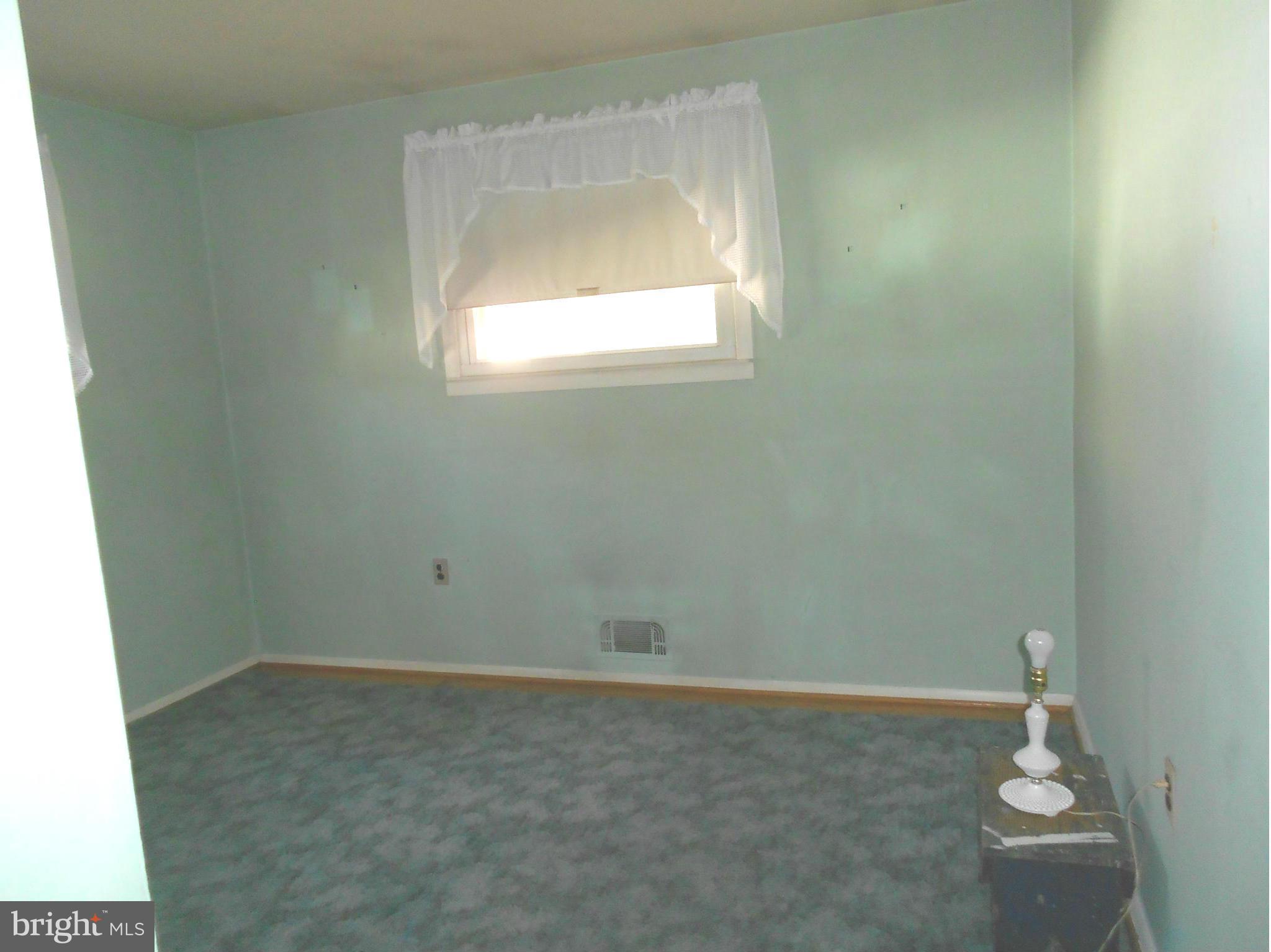 7704 Seekford Road Baltimore, MD 21219 - Photo 10 of 23 Hardwood under carpet