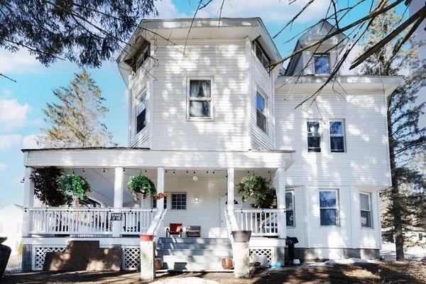 a front view of a building with green space
