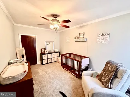 a bedroom with furniture and wooden floor