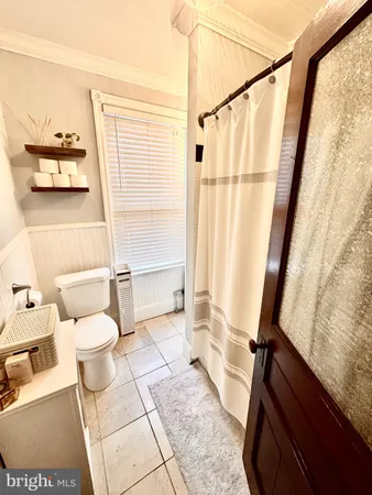 a bathroom with a toilet a sink and a shower