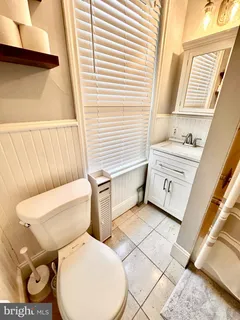 a white toilet sitting next to a window