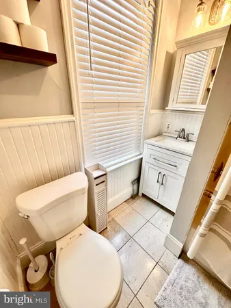 a white toilet sitting next to a window