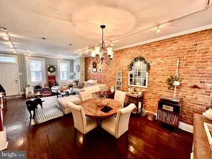 a living room with furniture a rug and a chandelier