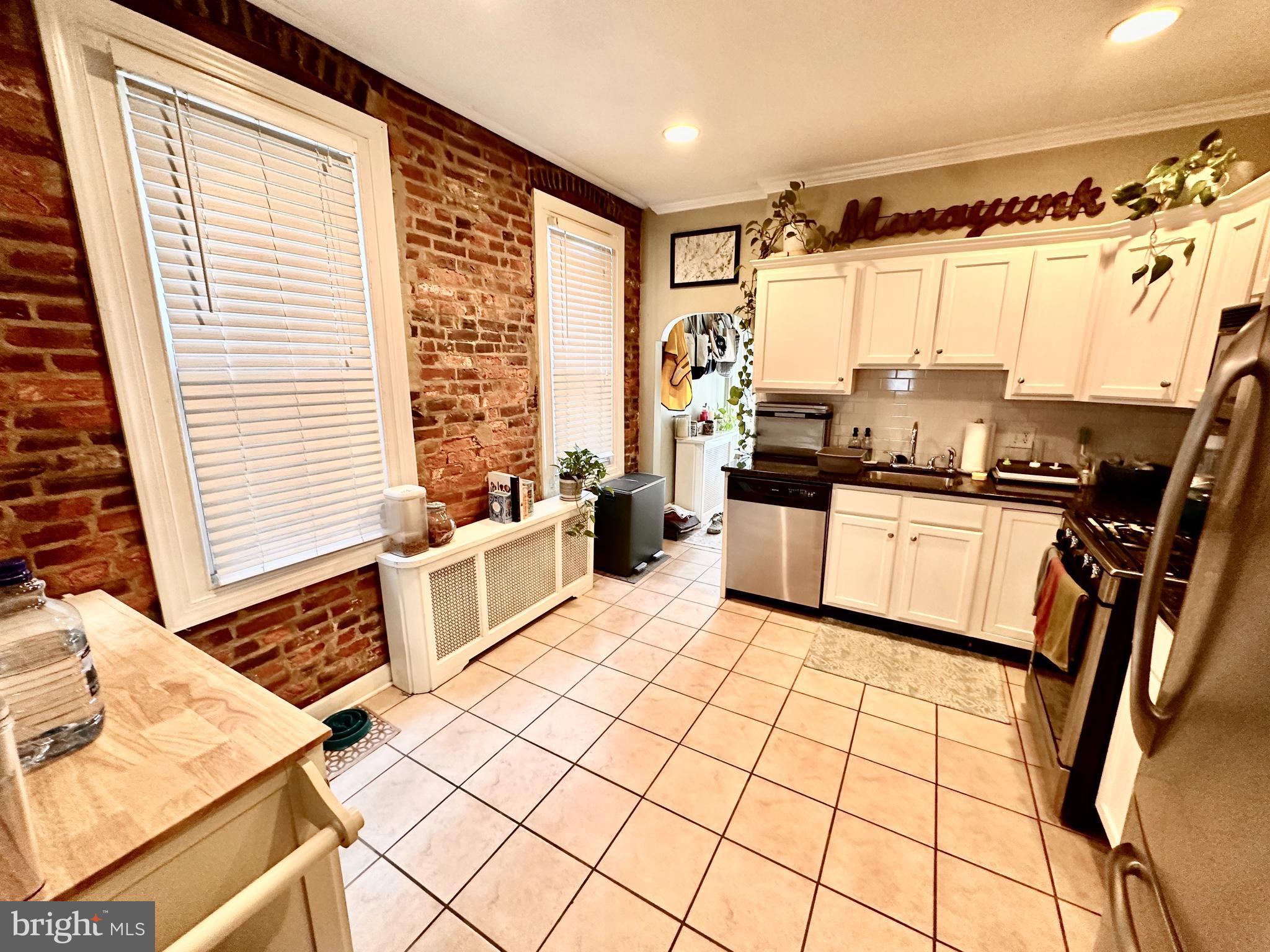 4531 Wilde Street Philadelphia, PA 19127 - Photo 6 of 23 a kitchen with a sink appliances cabinets and a large window