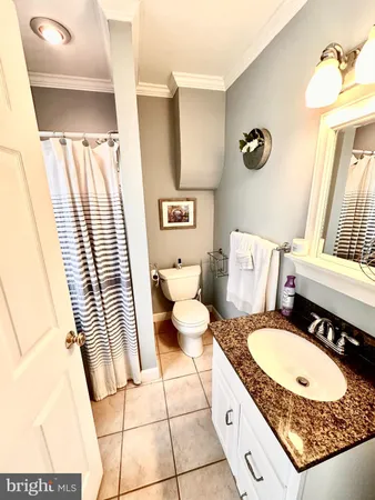 a bathroom with a sink mirror vanity and toilet
