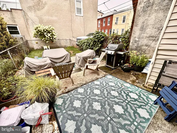a view of a chairs and table in backyard
