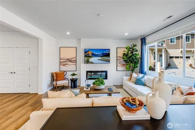 a living room with furniture fireplace and a large window