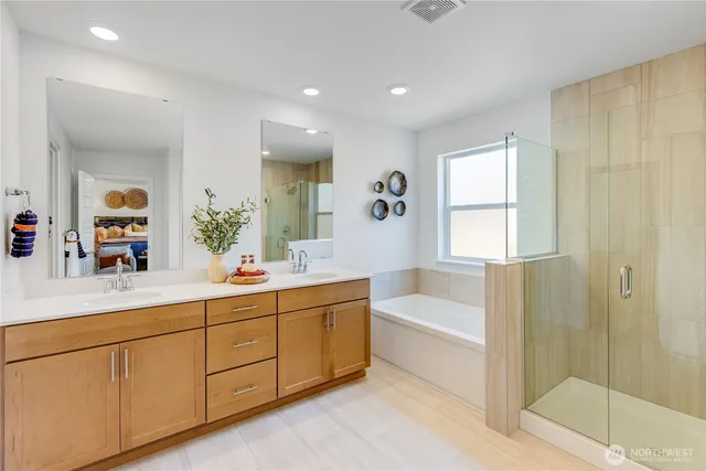 a bathroom with a tub sink and mirror