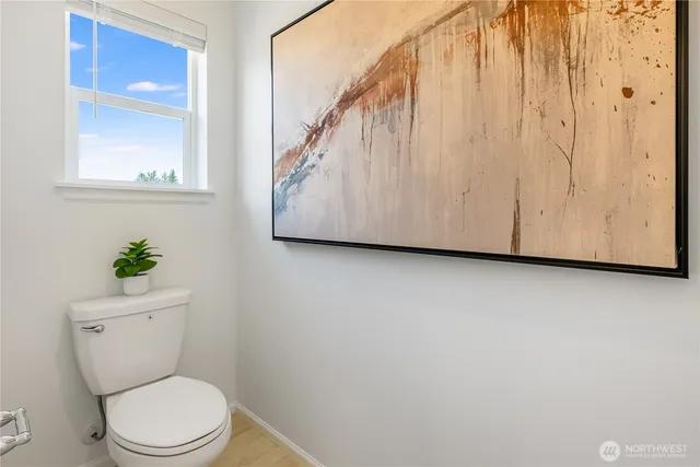 a white toilet sitting next to a bathroom sink