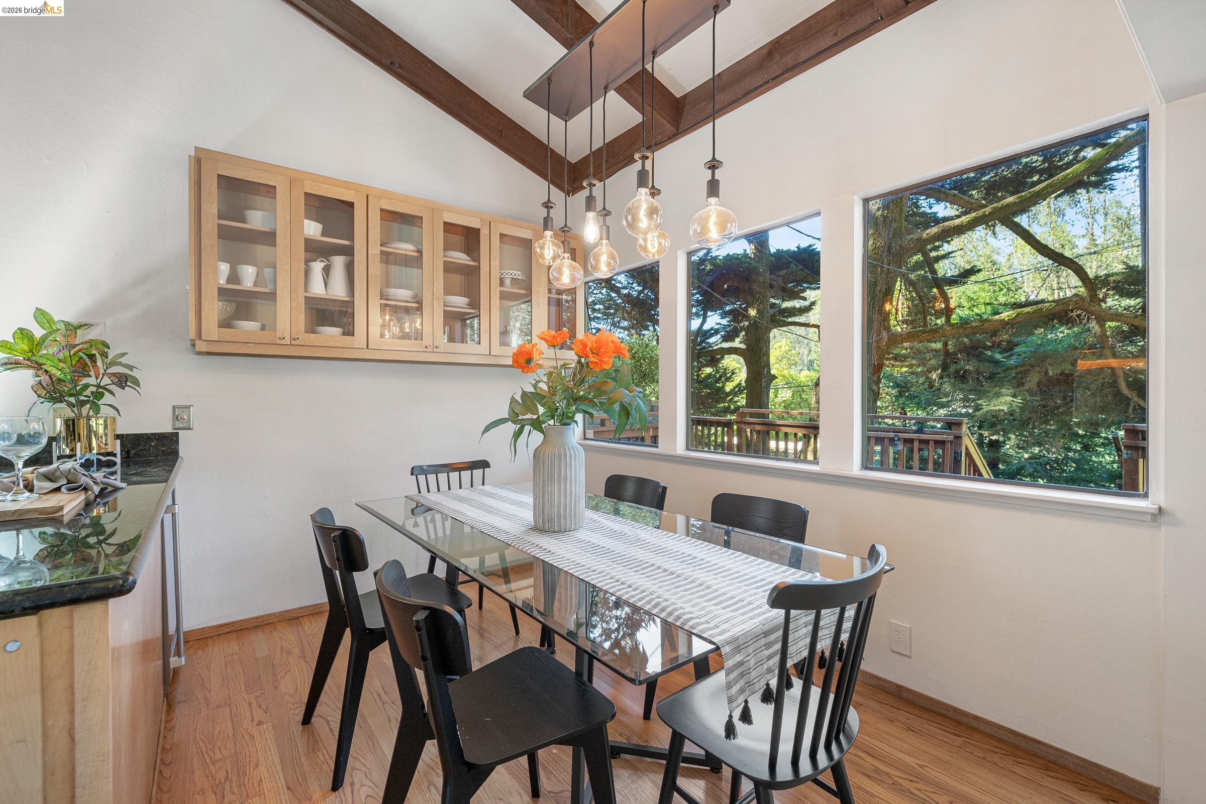 6600 Heather Ridge Way Oakland, CA 94611 - Photo 16 of 66 Dining area featuring vaulted ceilings with exposed wood beams