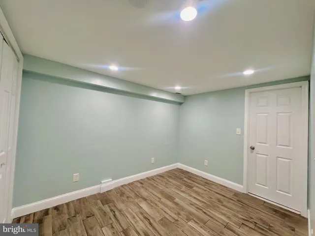 a view of room with wooden floor