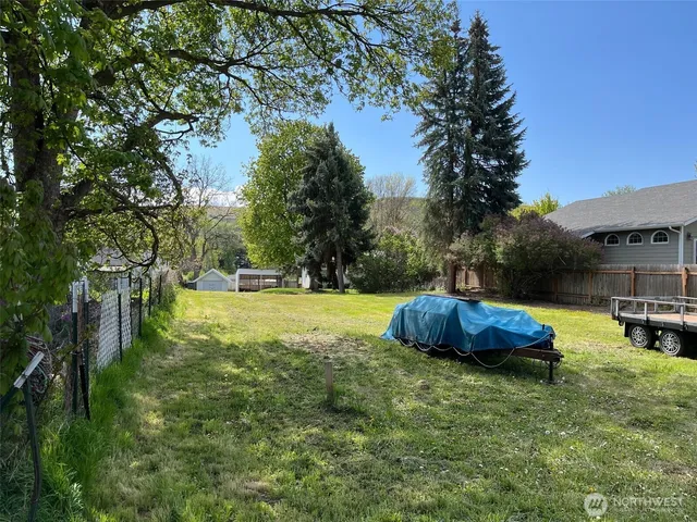 a view of backyard with swimming pool and outdoor seating