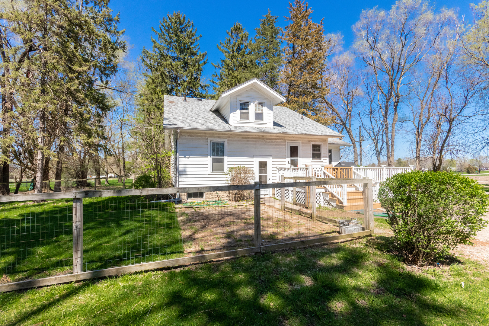 42W671 Jericho Road Sugar Grove, IL 60554 - Photo 6 of 31 a view of a white house next to a yard with big trees