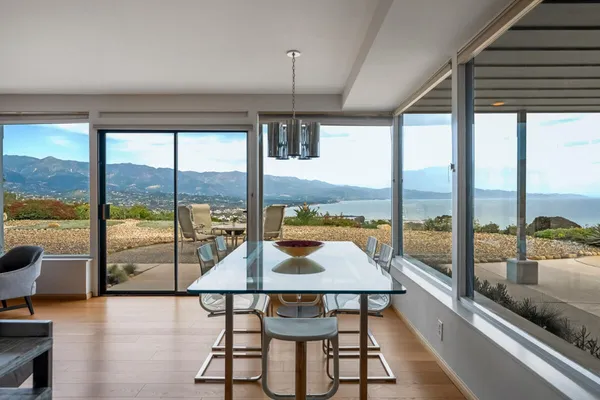 a living room with furniture a fireplace and city view