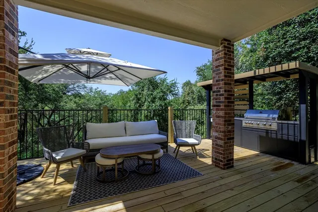 a patio with couches and a fire pit