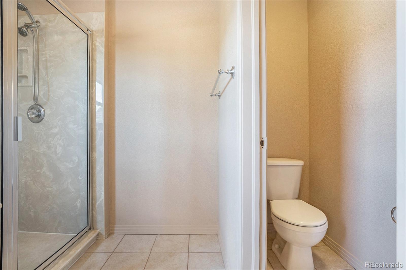 1131 Westmoreland Road Colorado Springs, CO 80907 - Photo 11 of 30 a bathroom with a toilet and a shower