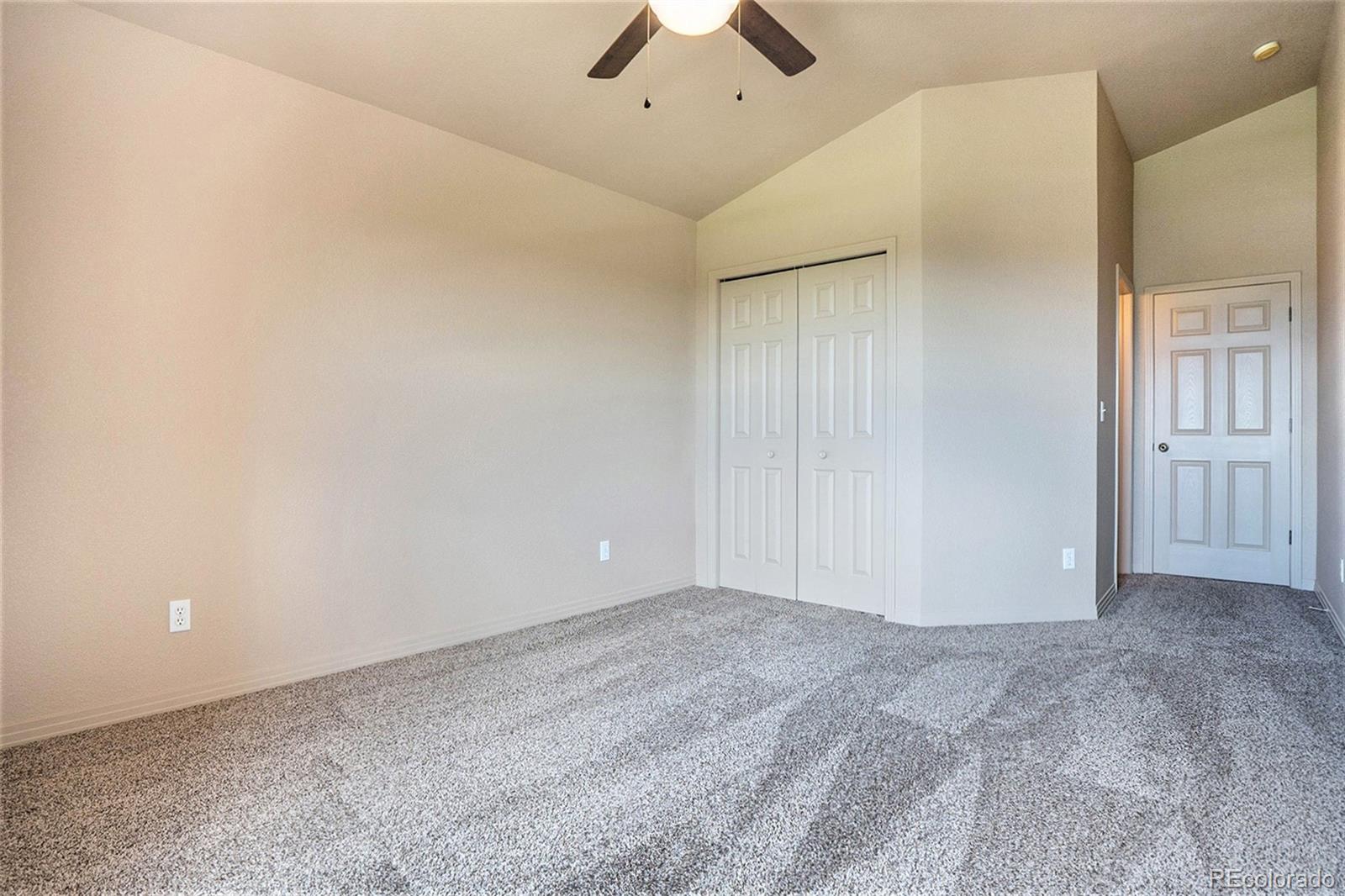 1131 Westmoreland Road Colorado Springs, CO 80907 - Photo 18 of 30 an empty room with a ceiling fan and a window