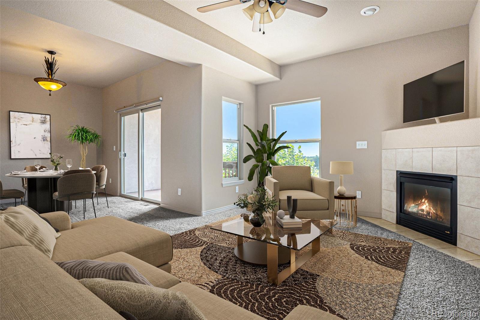 1131 Westmoreland Road Colorado Springs, CO 80907 - Photo 2 of 30 a living room with furniture a fireplace and a flat screen tv