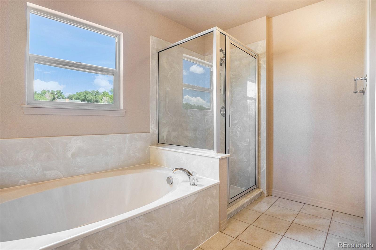 1131 Westmoreland Road Colorado Springs, CO 80907 - Photo 21 of 30 a bathroom with a bathtub and a shower